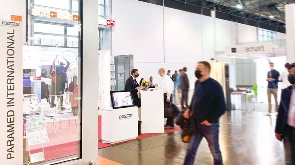 Paramed booth at Medica 2021 with visitors and staff engaging at the exhibition.