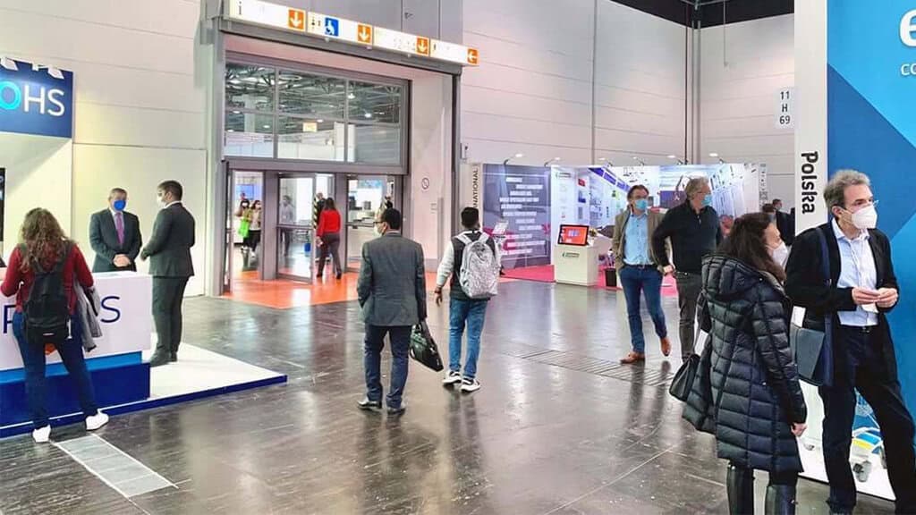Paramed booth at Medica 2021 medical exhibition with visitors and staff.